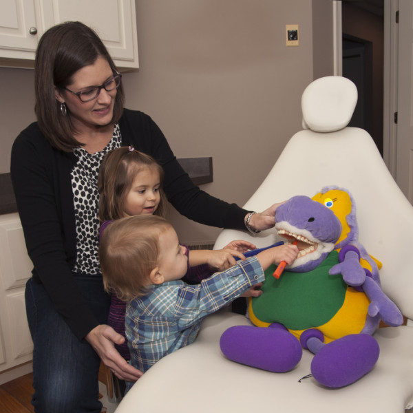 Dr. Erin Brown with Children Brushing Teeth of Stuffed Animal